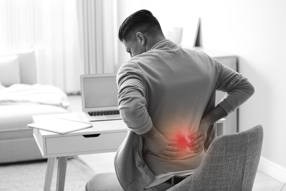 man-suffering-from-back-pain-workplace-bad-posture-problem.jpg